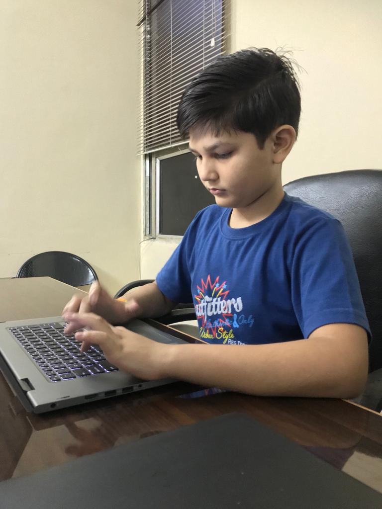 Meedhansh Kumar Gupta working at his laptop